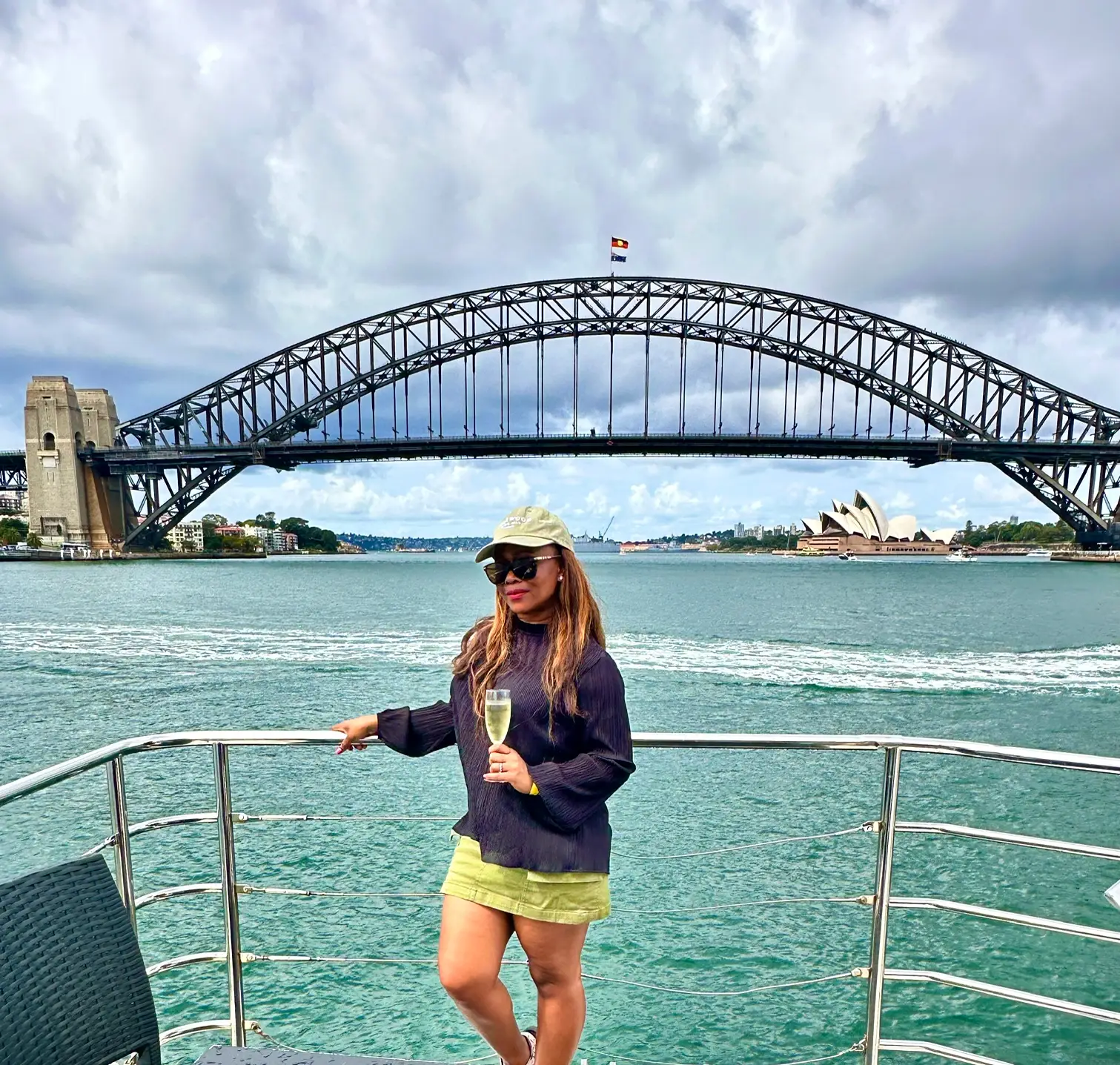 Claudine on catamaran in Sydney drinking champagne