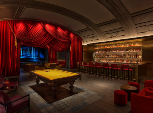 red hued bar with billiard pool table