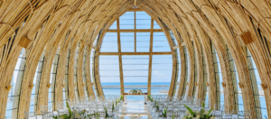 Apurva Chapel at The Apurva Kempinski Bali, with soaring curved architecture, white ceremony seating, and ocean views.
