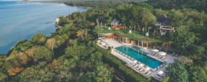 Lap pool surrounded by tropical greenery at Kamalaya wellness retreat on Koh Samui, Thailand.