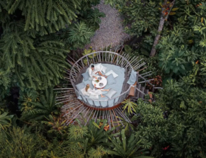 Couple enjoying breakfast in robes on a circular lounge deck surrounded by tropical greenery at Nay Palad Hideaway, Philippines.
